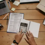 person organizing finances using simple systems for clarity and control